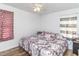 King-size bed in bright bedroom with wood floors and window curtains at 1717 Martin Luther King Dr, Rocky Mount, NC 27801