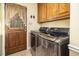 Laundry room with washer, dryer, and ample cabinet space at 185 Franklin Ln, Henderson, NC 27537