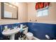 Clean bathroom with pedestal sink and blue walls at 104 Full Moon Ct, Garner, NC 27529