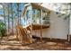 Wooden deck stairs leading to a sunroom addition at 104 Full Moon Ct, Garner, NC 27529