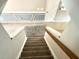 Indoor view of carpeted staircase with wood railing at 104 Full Moon Ct, Garner, NC 27529