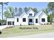 Modern two-story farmhouse style home with white siding, black roof, and a two-car garage at 2408 Toll Mill Ct, Raleigh, NC 27606