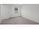 Well-lit bedroom with carpet and a door at 281 Logan Creek Dr, Zebulon, NC 27597
