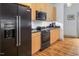 Modern kitchen with stainless steel appliances and light wood cabinets at 1002 Kenion Rd, Hillsborough, NC 27278