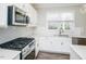 Modern kitchen with stainless steel appliances and white cabinets at 412 W Copenhaver Dr, Clayton, NC 27527