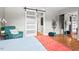 Bedroom with a queen bed, teal accent chair, and mirrored closet at 807 W Trinity Ave # 220, Durham, NC 27701