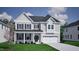 Two-story house with gray siding, a two-car garage, and a covered porch at 215 Augusta Pond Way # 156, Raleigh, NC 27603