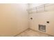 Laundry room with tile floor and overhead shelving at 252 E Webber Ln, Clayton, NC 27527