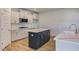 Kitchen island with dark cabinets and quartz countertop at 2802 Lacy Holt Rd, Graham, NC 27253