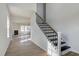 Elegant staircase with black metal railing and hardwood steps at 2802 Lacy Holt Rd, Graham, NC 27253