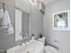 Modern bathroom with white sink and vanity, and stylish artwork at 122 N Harrington St # 1225, Raleigh, NC 27603