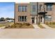 Modern townhome with brick and siding exterior, landscaping, and two-car parking at 1231 Shaw View Alley # 101, Raleigh, NC 27601