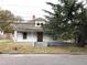 White house with front porch needs renovation at 313 E Umstead St, Durham, NC 27707