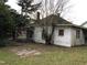 Side view of the house showing some damage at 313 E Umstead St, Durham, NC 27707