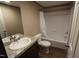 Bathroom with tub, toilet, vanity, and wood-look floor at 583 Madison'S Grove Ln, Henderson, NC 27537