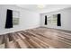 Bedroom with hardwood floors, dark blue curtains, and plenty of natural light at 1103 Kimball Crest Ct, Fuquay Varina, NC 27526