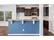 Kitchen features a breakfast bar with granite countertop and blue accent wall at 1103 Kimball Crest Ct, Fuquay Varina, NC 27526