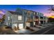 View of townhouses at sunset, showcasing garages and decks at 129 Pearl St # 6, Garner, NC 27529