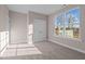 Well-lit bedroom featuring a large window and carpet at 129 Pearl St # 6, Garner, NC 27529