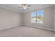 Well-lit bedroom with plush carpeting and large window offering natural light at 129 Pearl St # 6, Garner, NC 27529