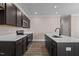 Modern kitchen with island, dark cabinetry, and quartz counters at 129 Pearl St # 6, Garner, NC 27529