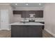 Modern kitchen with island, dark cabinetry, and quartz counters at 129 Pearl St # 6, Garner, NC 27529