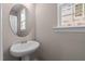 Small powder room with pedestal sink and oval mirror at 129 Pearl St # 6, Garner, NC 27529