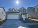 Two-story home with gray siding, white garage door, and landscaped lawn at 4208 Hunters Brook Run # Madison, Raleigh, NC 27616