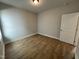 Bright bedroom with wood-look flooring and neutral walls at 445 Edison Rail Ln, Knightdale, NC 27545