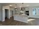 Modern kitchen with island, pantry, and stainless steel appliances at 445 Edison Rail Ln, Knightdale, NC 27545