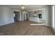 Open living room with kitchen view and hardwood floors at 445 Edison Rail Ln, Knightdale, NC 27545