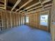 Unfinished bedroom with wood framing, windows, and exposed wiring at 585 Husketh Rd, Youngsville, NC 27596