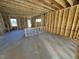 Unfinished living room with wood framing, exposed wiring and concrete floor at 585 Husketh Rd, Youngsville, NC 27596