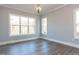 Bright dining room with large windows and wood floors at 6040 Scalybark Road, Durham, NC 27712