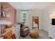 Bedroom with a crib, rocking chair, and a blush-colored accent wall at 246 Moore Creek Dr, Fuquay Varina, NC 27526