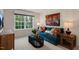Spacious bonus room with teal couch, large window, and wood media cabinet at 246 Moore Creek Dr, Fuquay Varina, NC 27526