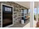 Inviting front porch with stone exterior, a bench, and a dark brown door at 246 Moore Creek Dr, Fuquay Varina, NC 27526