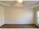 Bright main bedroom with hardwood flooring and a large window at 202 Beckingham Loop, Cary, NC 27519