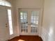 Bright entryway with hardwood floors and French doors at 202 Beckingham Loop, Cary, NC 27519