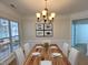 Bright dining room features a spacious wooden table and chandelier at 202 Beckingham Loop, Cary, NC 27519