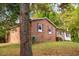 Brick ranch house with maroon shutters and a green lawn at 1 Westbury Pl, Durham, NC 27707