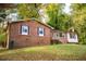 Brick ranch house with maroon shutters and a green lawn at 1 Westbury Pl, Durham, NC 27707