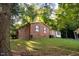 Brick ranch house nestled on a grassy hillside at 1 Westbury Pl, Durham, NC 27707