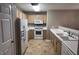 Galley kitchen with white appliances and light wood cabinets at 1513 Kenmore Dr # 1513, Clayton, NC 27520