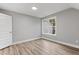 Spacious bedroom with gray walls, wood-look flooring, and abundant natural light at 1431 Alabama Ave, Sanford, NC 27332