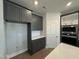 Kitchen with dark gray cabinets and white quartz countertops at 441 Edison Rail Ln, Knightdale, NC 27545