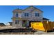 New two-story house with vinyl siding and a large dumpster in the yard at 88 Bering Cir, Angier, NC 27501