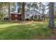 Brick home showcasing a large sunroom addition at 739 Silk Hope Lindley Mill Rd, Siler City, NC 27344