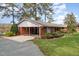 Brick ranch home with carport and landscaped yard at 739 Silk Hope Lindley Mill Rd, Siler City, NC 27344