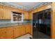 Bright kitchen features wood cabinets, granite countertops, and a black refrigerator at 739 Silk Hope Lindley Mill Rd, Siler City, NC 27344